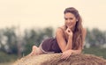 Beautiful woman relaxing on hay bale Royalty Free Stock Photo