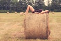 Beautiful woman relaxing on hay bale Royalty Free Stock Photo