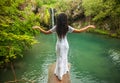 Beautiful woman relaxing in tropical waterfall Royalty Free Stock Photo