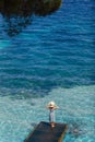 Beautiful woman relaxing on pier in Sardinia island, Italy Royalty Free Stock Photo