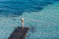 Beautiful woman relaxing on pier in Sardinia island, Italy Royalty Free Stock Photo