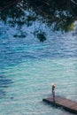 Beautiful woman relaxing on pier in Sardinia island, Italy Royalty Free Stock Photo