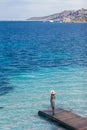 Beautiful woman relaxing on pier in Sardinia island, Italy Royalty Free Stock Photo