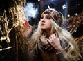 Beautiful woman relaxing in straw in autumn in smoky room