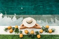 Beautiful Woman Relaxing In Swimming Pool With Pineapples. Royalty Free Stock Photo