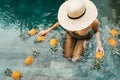 Beautiful Woman Relaxing In Swimming Pool With Pineapples. Healthy Lifestyle, Nutrition, Diet. Summer Vacation Royalty Free Stock Photo