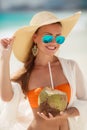 Beautiful woman removes thirst with coconut milk. Royalty Free Stock Photo