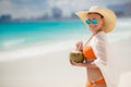 Beautiful woman removes thirst with coconut milk. Royalty Free Stock Photo