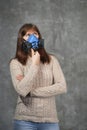 Beautiful woman in respirator stand on dark background