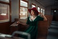 Beautiful woman in retro train, old wagon interior