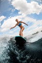 Beautiful woman rides down the river wave on wake boar Royalty Free Stock Photo