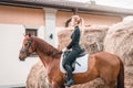 Beautiful woman rides a horse. Equestrian sport concept Royalty Free Stock Photo