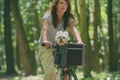Beautiful  woman riding a bike with her dog Royalty Free Stock Photo