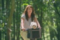 Beautiful  woman riding a bike with her dog Royalty Free Stock Photo