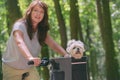 Beautiful  woman riding a bike with her dog Royalty Free Stock Photo