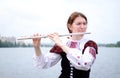 Beautiful woman on the river playing flute celtic medieval music