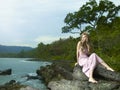 Beautiful woman on a rocky seashore