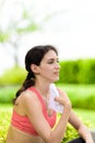 Beautiful woman runner has used a white towel wipe her face after running in the garden