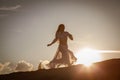 Beautiful woman running at sunset