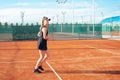 A beautiful woman runs around in the stadium. Tennis court, professional athlete in a dress suit. burning before