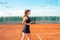 A beautiful woman runs around in the stadium. Tennis court, professional athlete in a dress suit. burning before