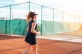 A beautiful woman runs around in the stadium. Tennis court, professional athlete in a dress suit. burning before