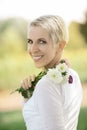 Beautiful woman in a rural field scene outdoors, with flowers