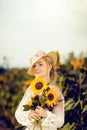 Beautiful woman in a rural field scene outdoors, with sunflowers Royalty Free Stock Photo