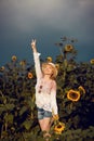 Beautiful woman in a rural field scene outdoors, with sunflowers and sunhat Royalty Free Stock Photo