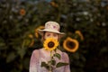 Beautiful woman in a rural field scene outdoors, with sunflowers Royalty Free Stock Photo