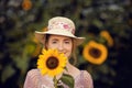 Beautiful woman in a rural field scene outdoors, with sunflowers Royalty Free Stock Photo