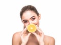 Beautiful woman`s face cover mouth with juicy orange isolated on white background. Skin care, cosmetology concept. Royalty Free Stock Photo