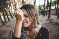Beautiful woman`s face sobbing in disgust as she rests her head on her hand Royalty Free Stock Photo