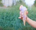 Beautiful woman's hand holding a colorful ice-cream cone. Close up. Outdoor. Summer time Royalty Free Stock Photo