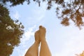 Beautiful woman`s legs on the sky background. Natural ecological photo. Perfect travel and girl`s rest day outdoors. Pine trees Royalty Free Stock Photo