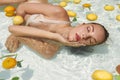 Beautiful Woman`s Portrait In Pool With Citrus. Model In Bikini Enjoying Sunny Day At SPA. Royalty Free Stock Photo