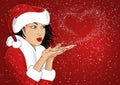 Beautiful woman in Santa Claus costume blowing snowflakes from her hands. Royalty Free Stock Photo