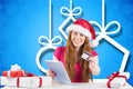 Beautiful woman in santa hat doing online shopping with credit card on digital tablet Royalty Free Stock Photo