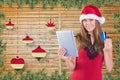 Beautiful woman in santa hat doing online shopping with credit card on digital tablet Royalty Free Stock Photo