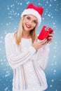 Beautiful woman with santa hat holding a small red gift box Royalty Free Stock Photo
