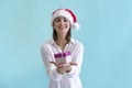 Beautiful woman in Santa hat holds gift box Royalty Free Stock Photo