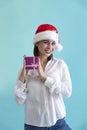 Beautiful woman in Santa hat holds gift box Royalty Free Stock Photo