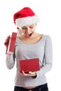 Beautiful woman in santa hat and opening present.