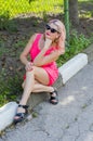 Beautiful woman sat down on the curb in the Park Royalty Free Stock Photo