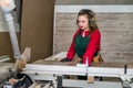 Beautiful woman sawing wooden plank in carpentry Royalty Free Stock Photo