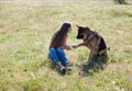 Beautiful woman schools a German Shepherd Dog friend Royalty Free Stock Photo