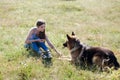 Beautiful woman schools a German Shepherd Dog friend Royalty Free Stock Photo