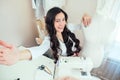 Beautiful woman seamstress with long hair does selfie. tailor creates a collection of clothes on the background of a