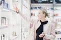 Beautiful woman shopping in beauty store. Royalty Free Stock Photo