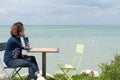 Beautiful woman on shore of Atlantic ocean in a cafe in Ile de Re Island France